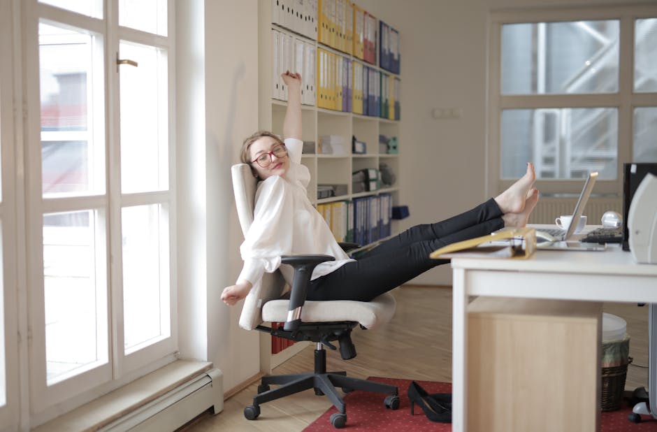 Person doing desk stretches in bright office space